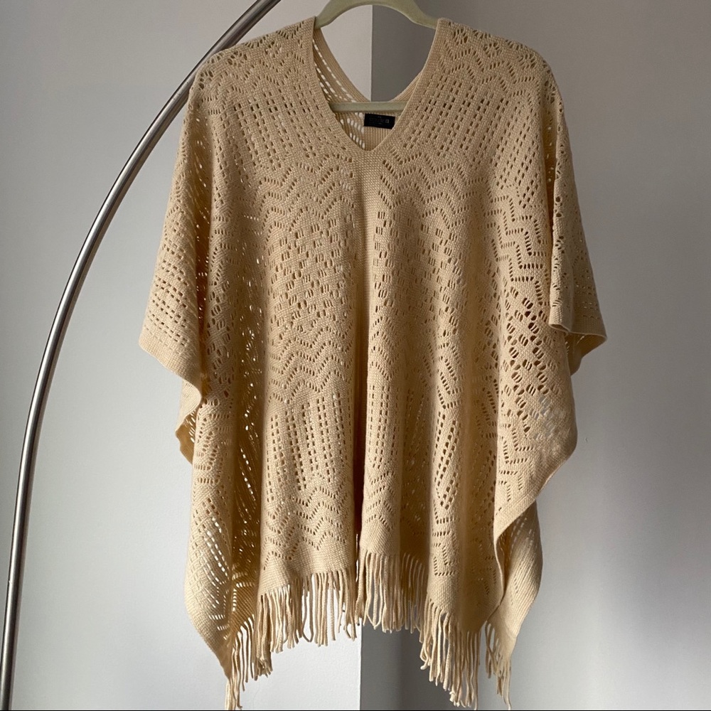 Tan boho poncho with fringe and cutouts